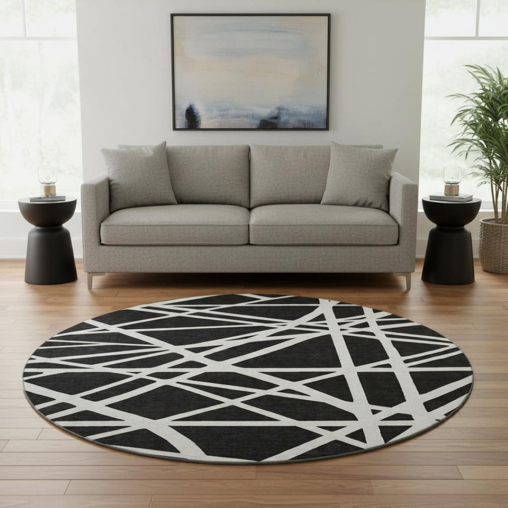 HomeRoots 8' Black & Ivory Geometric Washable Round Rug - Durable, UV-Protected, Ideal for Homes with Kids & Pets 681572