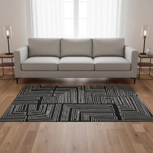HomeRoots 5' X 8' Stylish Black and Ivory Geometric Washable Area Rug - Durable, UV Protected, Perfect for Families 681949