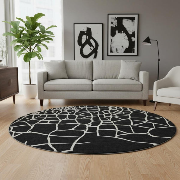 HomeRoots 8' Black And Ivory Abstract Geometric Round Rug - Washable, UV Protected, Non-Slip for Active Homes 682256