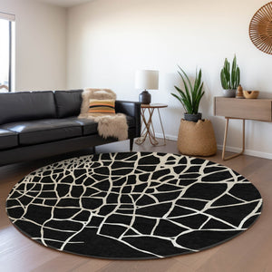 HomeRoots 8' Black And Ivory Abstract Geometric Round Rug - Washable, UV Protected, Non-Slip for Active Homes 682256