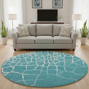HomeRoots 8' Teal and Ivory Abstract Geometric Round Rug - Washable, UV Protected, Perfect for Active Homes! 682316