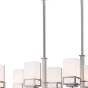 HomeRoots Eight Light Dimmable Chandelier with Sleek Cylinder Shades for Modern Ambiance in Any Space 687149