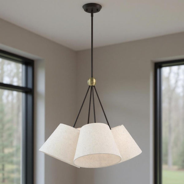 HomeRoots Four Light Dimmable Chandelier with Elegant Cylinder Shades for Modern Home Ambiance and Style 687320