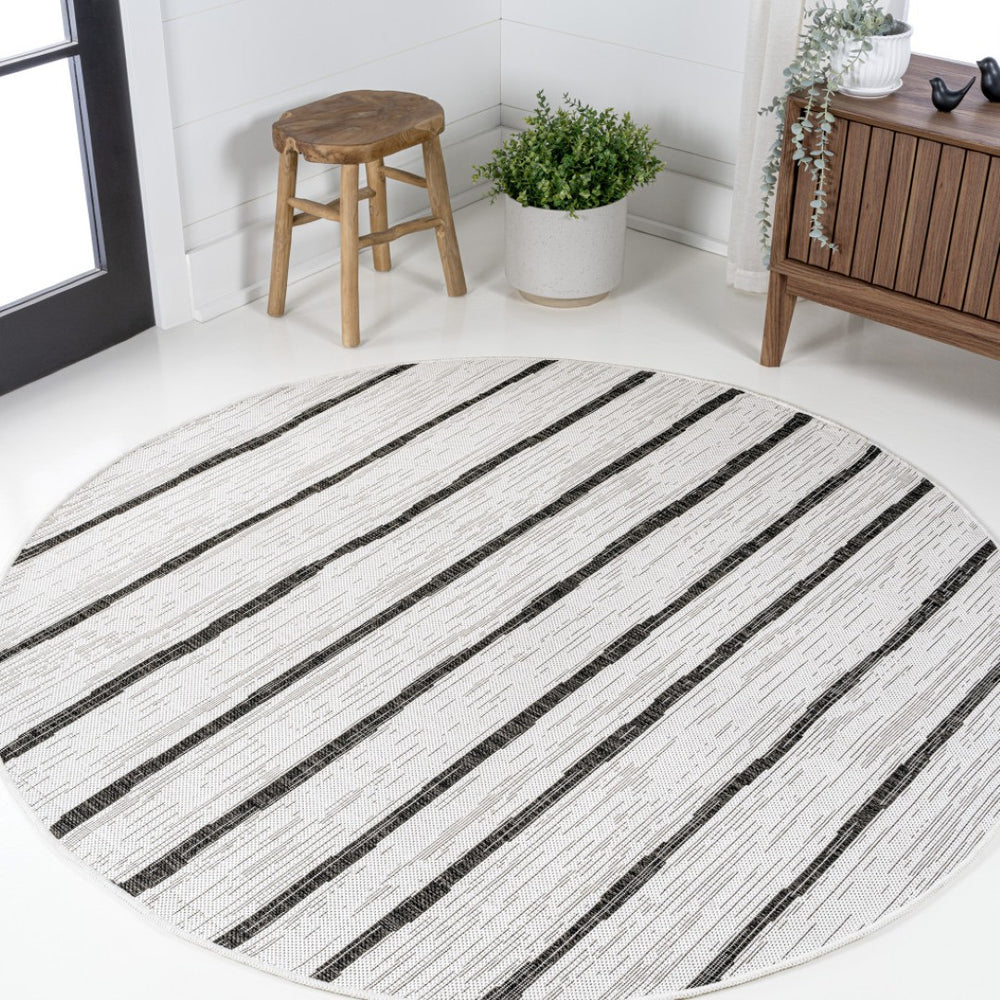 HomeRoots 6' Ivory and Black Round Striped Area Rug - Versatile Indoor/Outdoor Decor, Easy-Care and Durable 704560