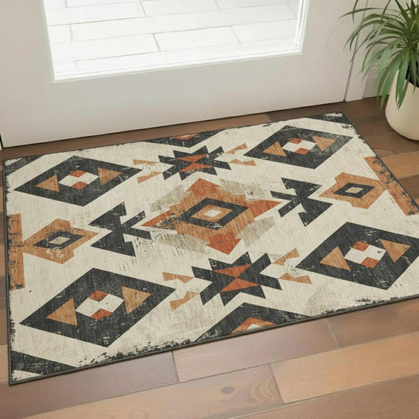 HomeRoots 5' X 8' Southwestern Area Rug in Ivory, Orange & Charcoal - Washable, UV Protected & Stain Resistant 706753
