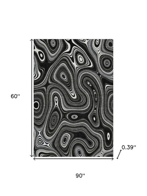 HomeRoots 8' Black and Ivory Geometric Round Rug - Washable, UV Protected, Durable Polyester for Modern Spaces 717708