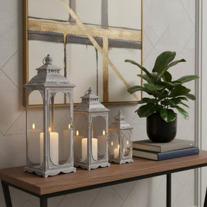 HomeRoots Set of Three Rustic Glass and Stainless Steel Lantern Candle Holders for Cozy Ambiance and Style 719764
