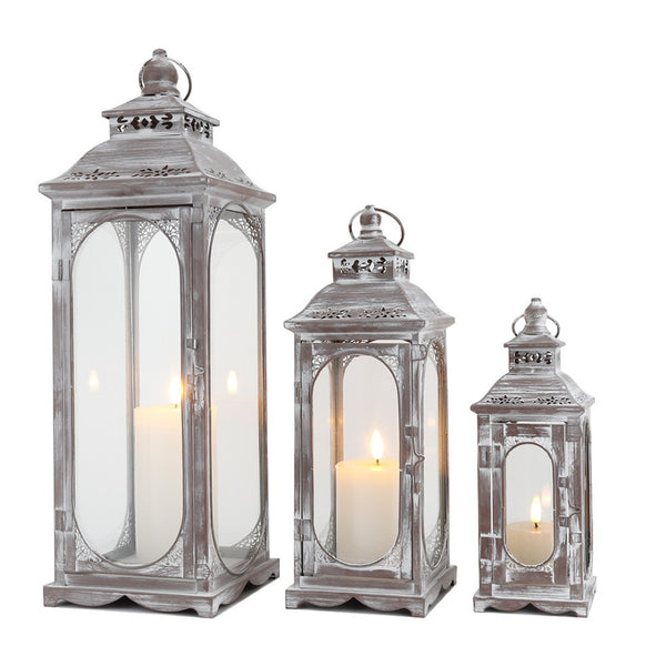 HomeRoots Set of Three Rustic Glass and Stainless Steel Lantern Candle Holders for Cozy Ambiance and Style 719764