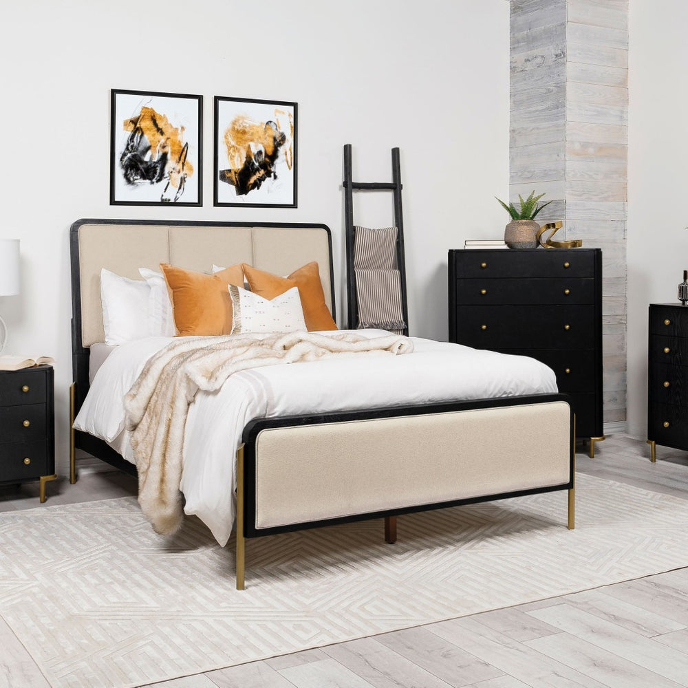 English Elm Benson Eastern King Panel Bed with Cream Upholstery and Aged Brass Leg Accents Black B062S01913