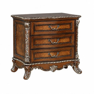 English Elm Devany 3-drawer Antique Oak Bedside Chest with Carved Scrollwork and Champagne Accents B2770P520678