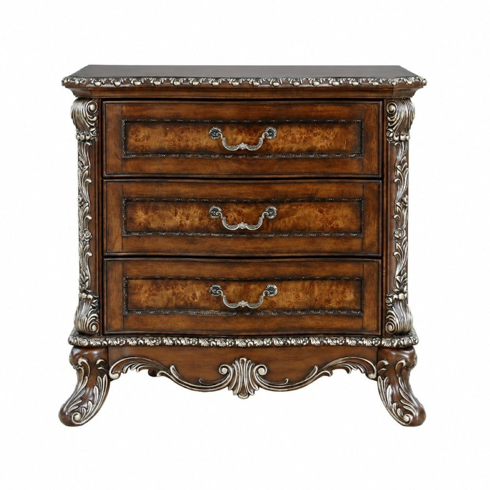 English Elm Devany 3-drawer Antique Oak Bedside Chest with Carved Scrollwork and Champagne Accents B2770P520678