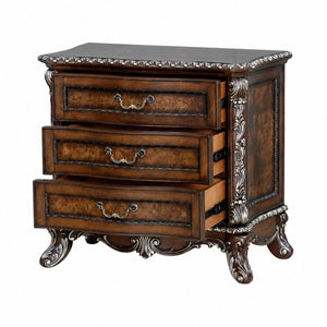English Elm Devany 3-drawer Antique Oak Bedside Chest with Carved Scrollwork and Champagne Accents B2770P520678