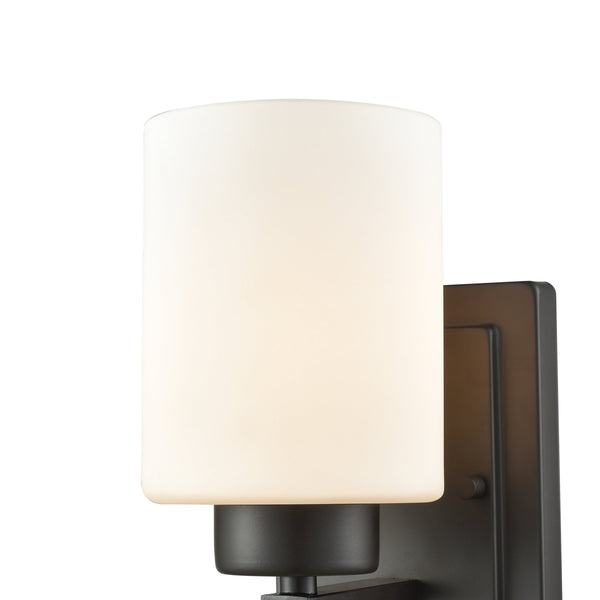 Thomas Lighting Summit Place Transitional Wall Sconce Brushed Metal with Cylindrical Glass Shade Bronze CN579171