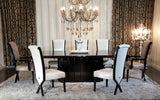 Two 43.5' White Leatherette and Black Wood Dining Chairs with X Shaped Rear Legs