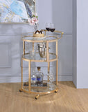 Three Tiered Metal Serving Cart with Glass Inserted Shelves and Curved Side Handle, Gold