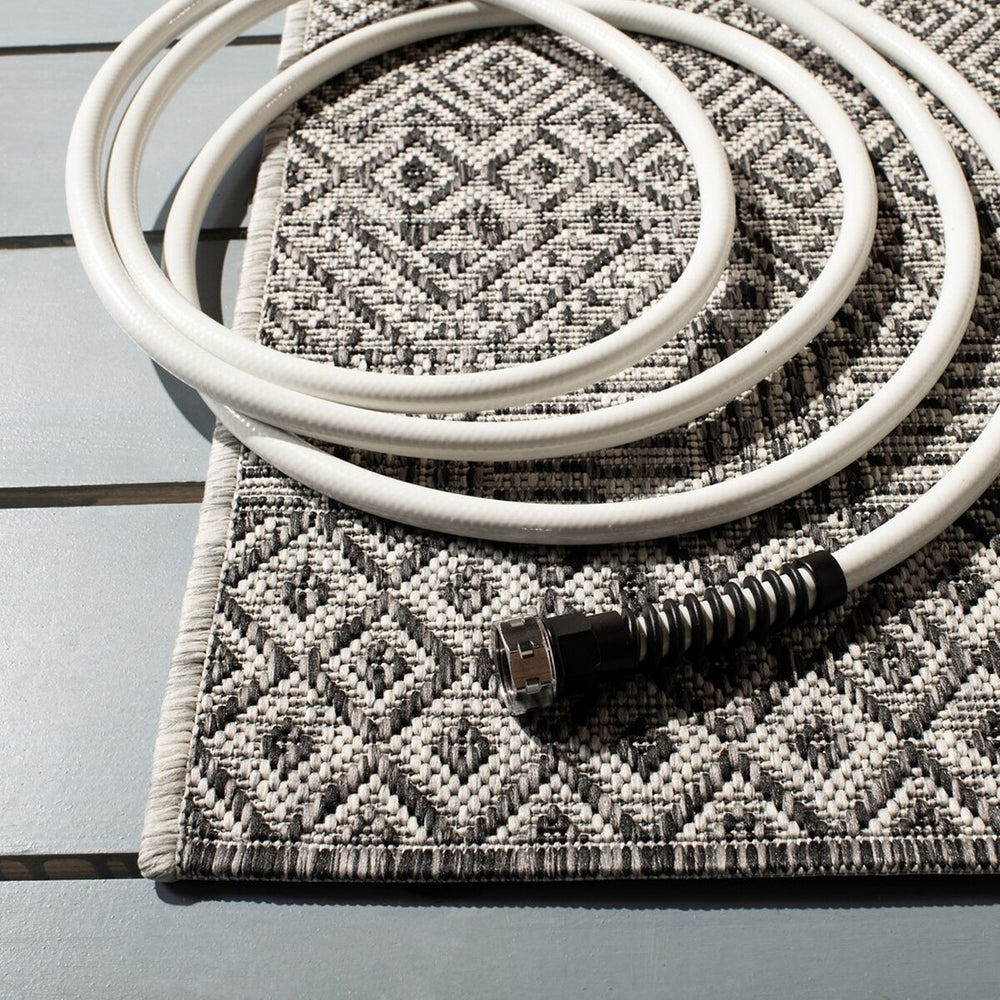 Courtyard  Outdoor Power Loomed 85.4% Polypropylene, 10.4% Polyester, 4.2% Latex Rug Grey / Black
